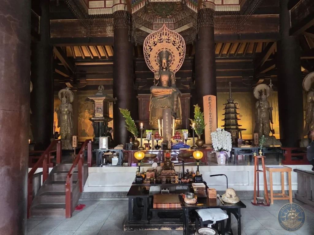 Kobe Japan Cruise Port Guide 2026 – Insider Tips & One Day Itinerary 40 The ornate interior altar of Kondo Main Hall at Shitennoji Temple featuring a large golden Prince Shotoku (Kannon) statue flanked by guardian deities, candles, and traditional ritual offerings in Osaka; ideal for a Kobe Japan Cruise Port Guide, DIY Kobe Cruise Port to City Center, Things to do in Kobe from cruise ship, Westerdam Kobe Docking Location, or One day in Kobe Japan itinerary, by Danny and Peter.