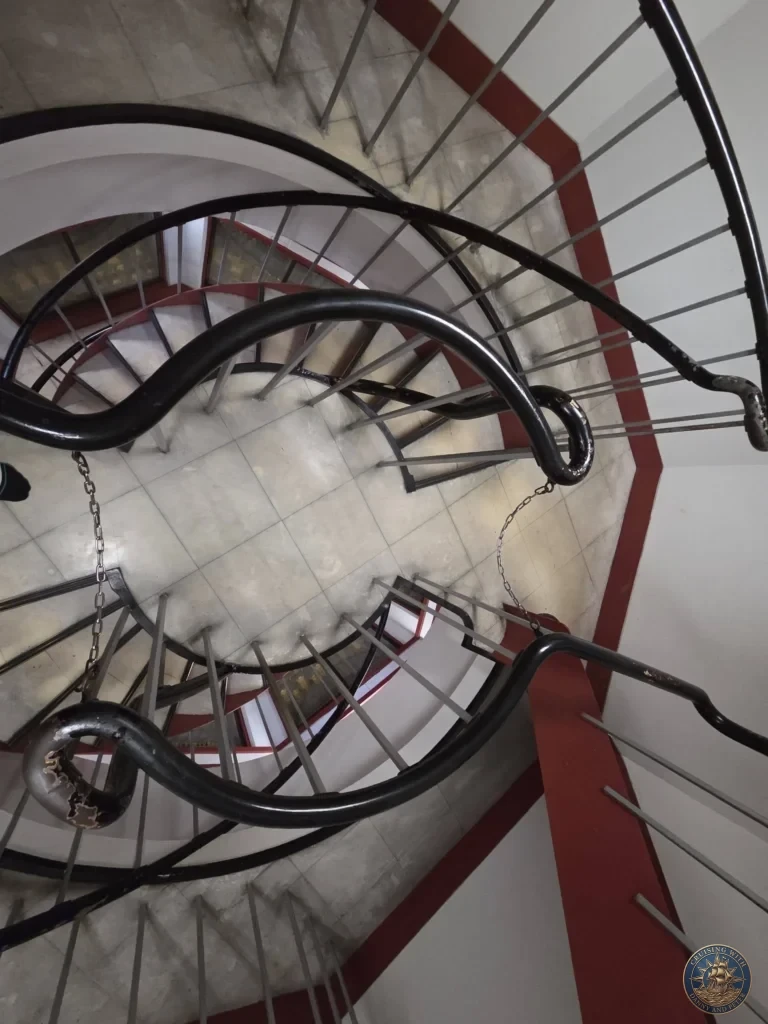 Kobe Japan Cruise Port Guide 2026 – Insider Tips & One Day Itinerary 133 A dynamic top-down view looking into the center of the black metal spiral staircase inside the five-story pagoda at Shitennoji Temple in Osaka, Japan; ideal for a Kobe Japan Cruise Port Guide, DIY Kobe Cruise Port to City Center, Things to do in Kobe from cruise ship, MS Westerdam Kobe Docking Location, or One day in Kobe Japan itinerary, by Danny and Peter.