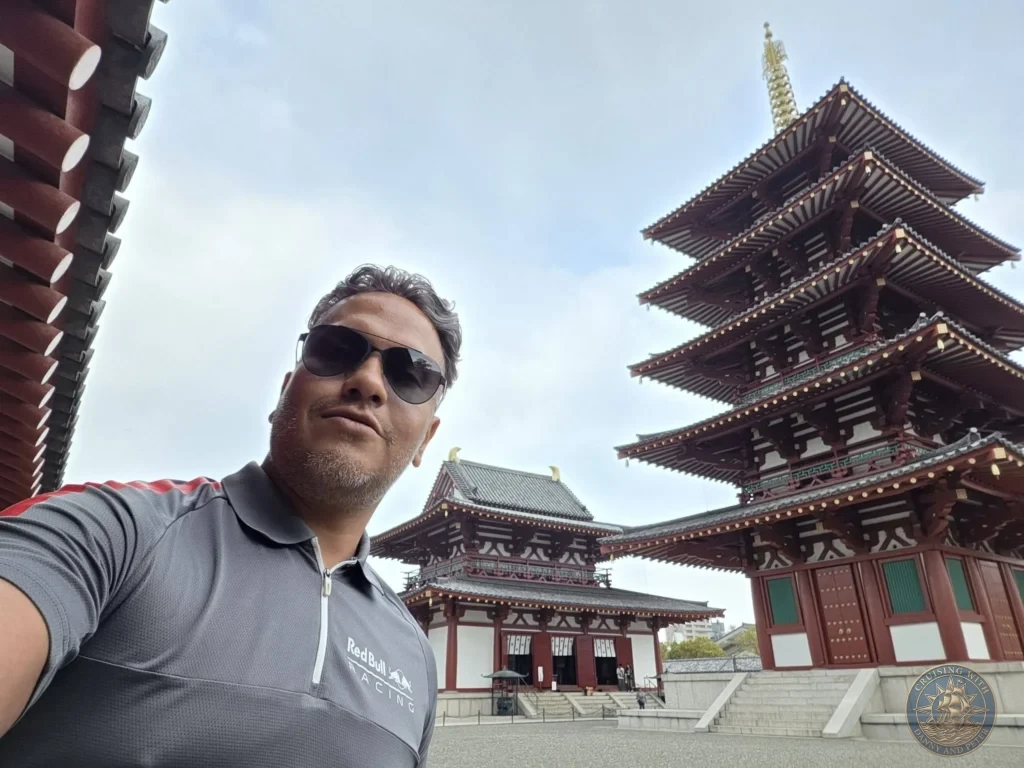 Kobe Japan Cruise Port Guide 2026 – Insider Tips & One Day Itinerary 147 Danny wearing sunglasses in a selfie shot in front of the iconic five-story pagoda and main hall at Shitennoji Temple in Osaka, Japan; ideal for a Kobe Japan Cruise Port Guide, DIY Kobe Cruise Port to City Center, Things to do in Kobe from cruise ship, MS Westerdam Kobe Docking Location, or One day in Kobe Japan itinerary, by Danny and Peter.