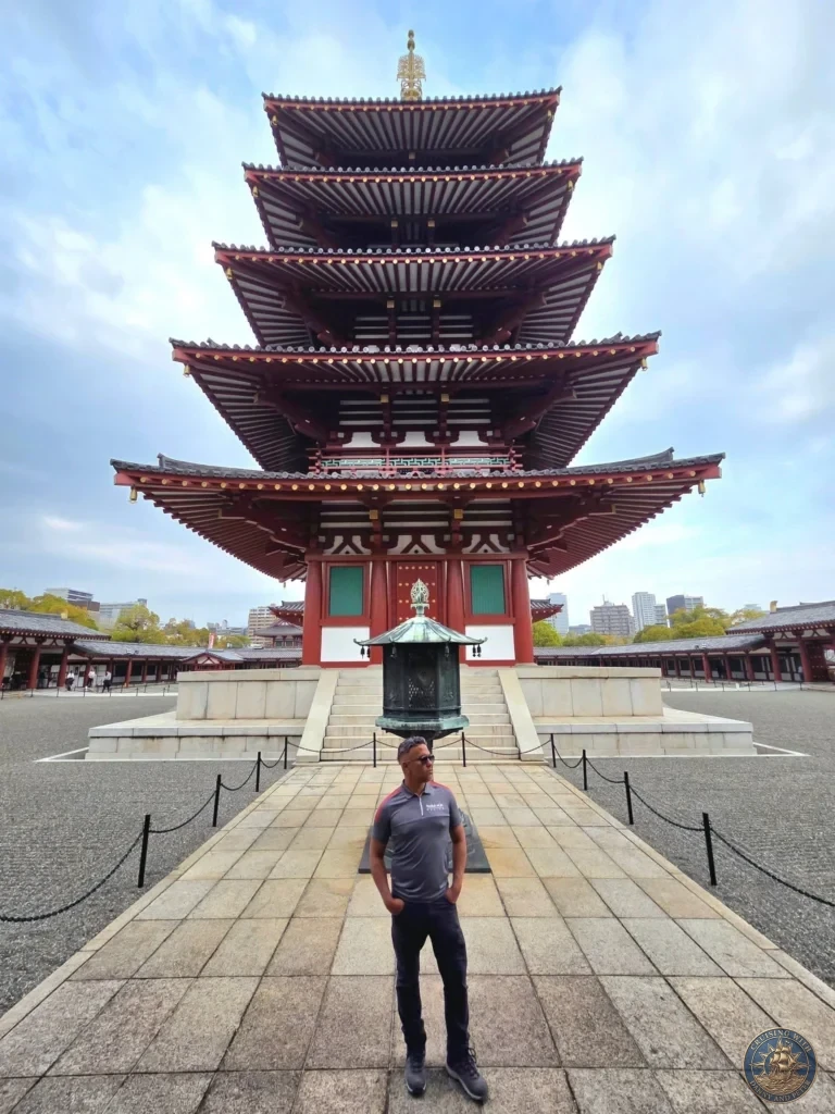 Kobe Japan Cruise Port Guide 2026 – Insider Tips & One Day Itinerary 140 Danny standing along the central stone pathway in front of a bronze lantern and the iconic five-story pagoda at Shitennoji Temple in Osaka, Japan; ideal for a Kobe Japan Cruise Port Guide, DIY Kobe Cruise Port to City Center, Things to do in Kobe from cruise ship, MS Westerdam Kobe Docking Location, or One day in Kobe Japan itinerary, by Danny and Peter.