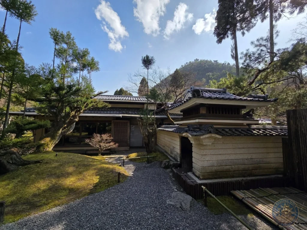 Kobe Japan Cruise Port Guide 2026 – Insider Tips & One Day Itinerary 79 Traditional Japanese buildings with tiled roofs along a gravel path in the mossy gardens of Shozan Resort under a blue sky in Kyoto, Japan. Peaceful garden stop from Kobe port day. Kobe Japan Cruise Port Guide | DIY Kobe Cruise Port to City Center | Things to do in Kobe from cruise ship | Westerdam Kobe Docking Location | One day in Kobe Japan itinerary by Danny and Peter.