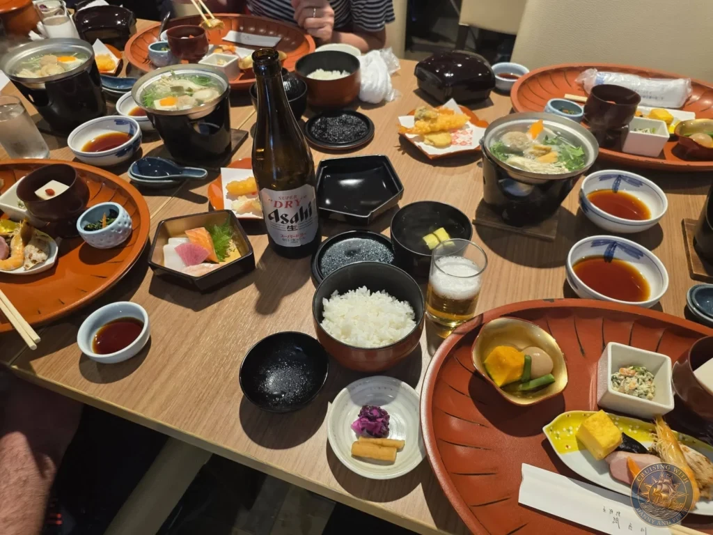 Kobe Japan Cruise Port Guide 2026 – Insider Tips & One Day Itinerary 27 Traditional Japanese multi-course lunch with rice, soup, sashimi, tempura, and Asahi Super Dry beer on a wooden table at Shozan Resort Garden in Kyoto, Japan. Delicious meal stop from Kobe port day. Kobe Japan Cruise Port Guide | DIY Kobe Cruise Port to City Center | Things to do in Kobe from cruise ship | Westerdam Kobe Docking Location | One day in Kobe Japan itinerary by Danny and Peter.