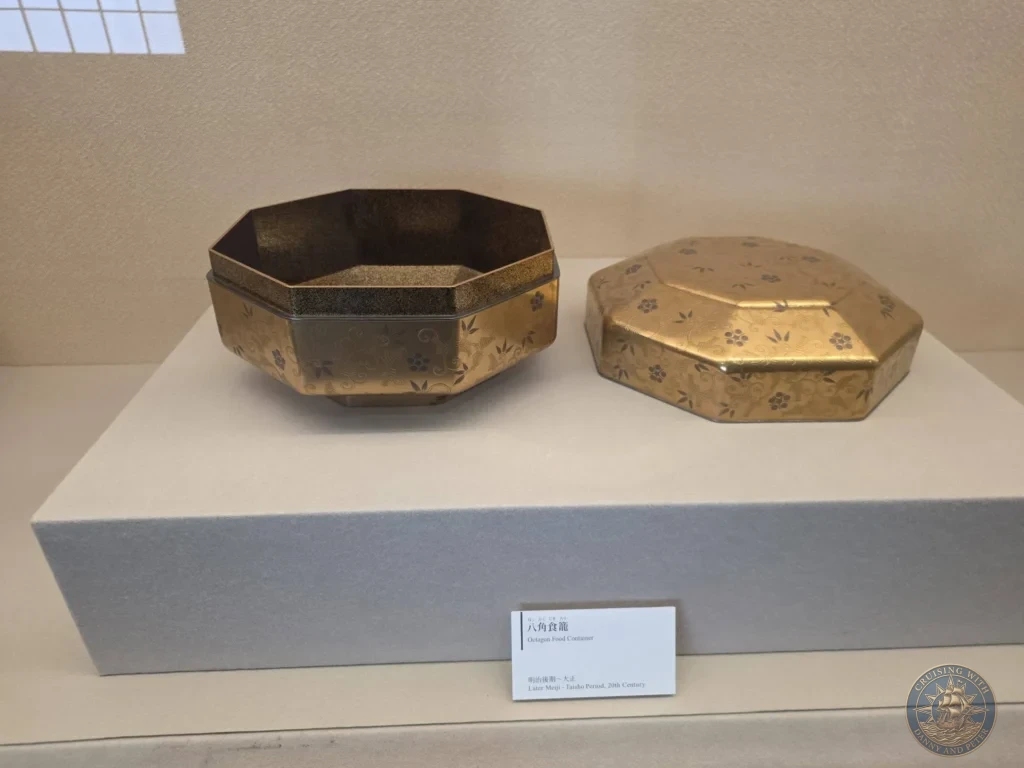An intricate gold maki-e octagon food container from the later Meiji to Taisho period on display inside the Adachi Museum of Art during a cruise shore excursion at Sakaiminato Japan Cruise Port Guide, DIY Sakaiminato Cruise Port to City Center, Things to do in Sakaiminato from cruise ship, Westerdam Sakaiminato Docking Location, One day in Sakaiminato Japan itinerary by Danny and Peter.