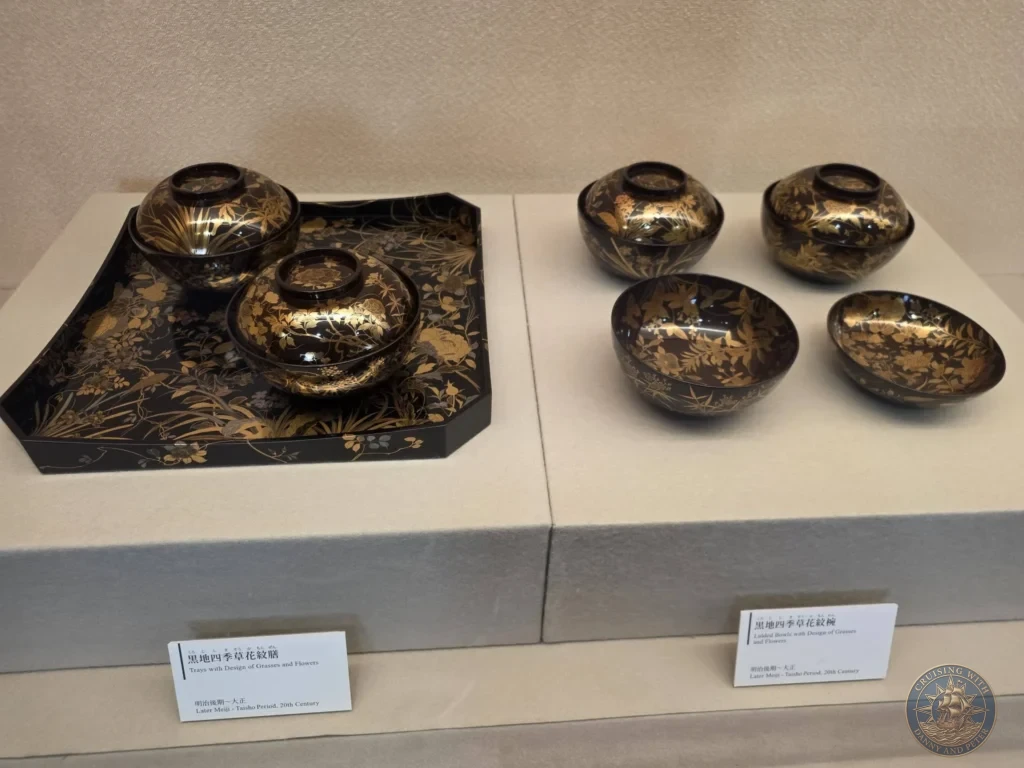 Traditional Japanese black lacquer trays and lidded bowls decorated with intricate gold floral designs on display inside the Adachi Museum of Art during a shore excursion from Sakaiminato Japan Cruise Port Guide, DIY Sakaiminato Cruise Port to City Center, Things to do in Sakaiminato from cruise ship, Westerdam Sakaiminato Docking Location, One day in Sakaiminato Japan itinerary by Danny and Peter.