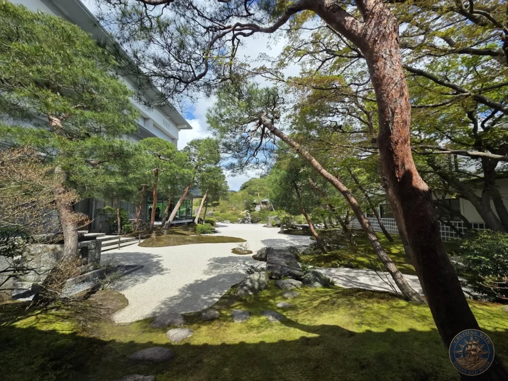 Shaded moss garden with manicured pine trees, raked white gravel paths, and glass pavilion view at the Adachi Museum of Art visited during a shore excursion from Sakaiminato Japan Cruise Port Guide, DIY Sakaiminato Cruise Port to City Center, Things to do in Sakaiminato from cruise ship, Westerdam Sakaiminato Docking Location, One day in Sakaiminato Japan itinerary by Danny and Peter.