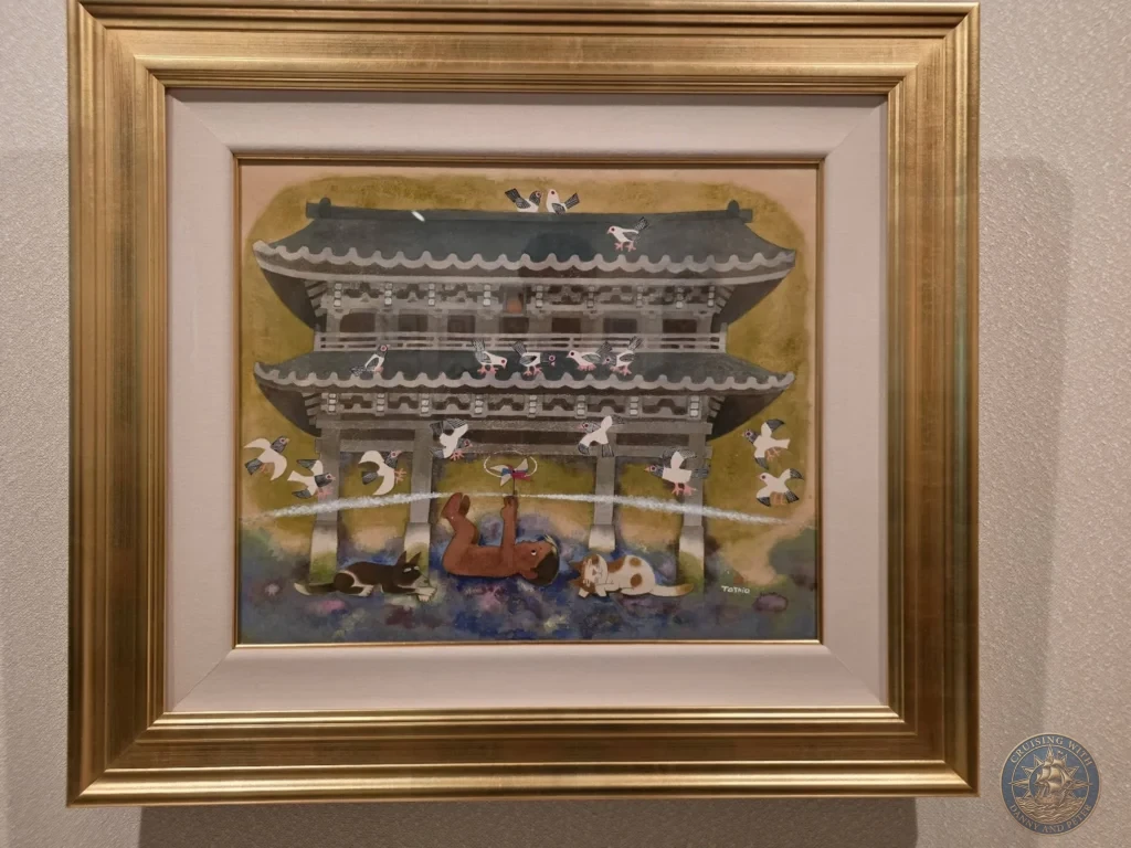 Framed painting depicting flying birds and a traditional Japanese temple gate on display in the Children's Picture Gallery at the Adachi Museum of Art during a shore excursion from Sakaiminato Japan Cruise Port Guide, DIY Sakaiminato Cruise Port to City Center, Things to do in Sakaiminato from cruise ship, Westerdam Sakaiminato Docking Location, One day in Sakaiminato Japan itinerary by Danny and Peter.