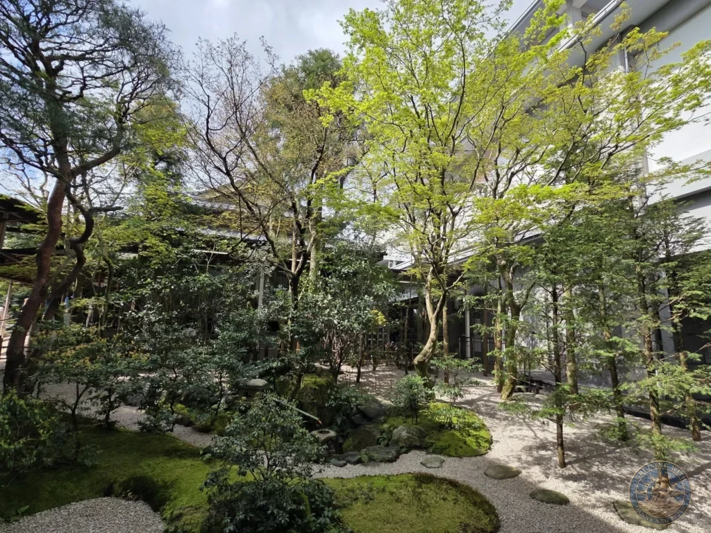 Lush green trees and mossy stone stepping paths in an outdoor courtyard garden at the Adachi Museum of Art during a shore excursion from Sakaiminato Japan Cruise Port Guide, DIY Sakaiminato Cruise Port to City Center, Things to do in Sakaiminato from cruise ship, Westerdam Sakaiminato Docking Location, One day in Sakaiminato Japan itinerary by Danny and Peter.