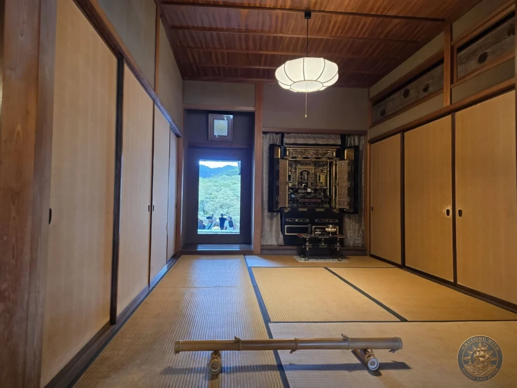 Traditional Japanese tatami room featuring a window cutout framing garden greenery like a living picture painting alongside a butsudan shrine at the Adachi Museum of Art during a shore excursion from Sakaiminato Japan Cruise Port Guide, DIY Sakaiminato Cruise Port to City Center, Things to do in Sakaiminato from cruise ship, Westerdam Sakaiminato Docking Location, One day in Sakaiminato Japan itinerary by Danny and Peter.