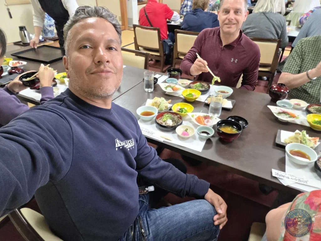 Danny taking a selfie with Peter sitting across the table holding chopsticks over a traditional Japanese lunch set at Kyoragi restaurant in Matsue during a shore excursion from Sakaiminato Japan Cruise Port Guide, DIY Sakaiminato Cruise Port to City Center, Things to do in Sakaiminato from cruise ship, Westerdam Sakaiminato Docking Location, One day in Sakaiminato Japan itinerary by Danny and Peter.