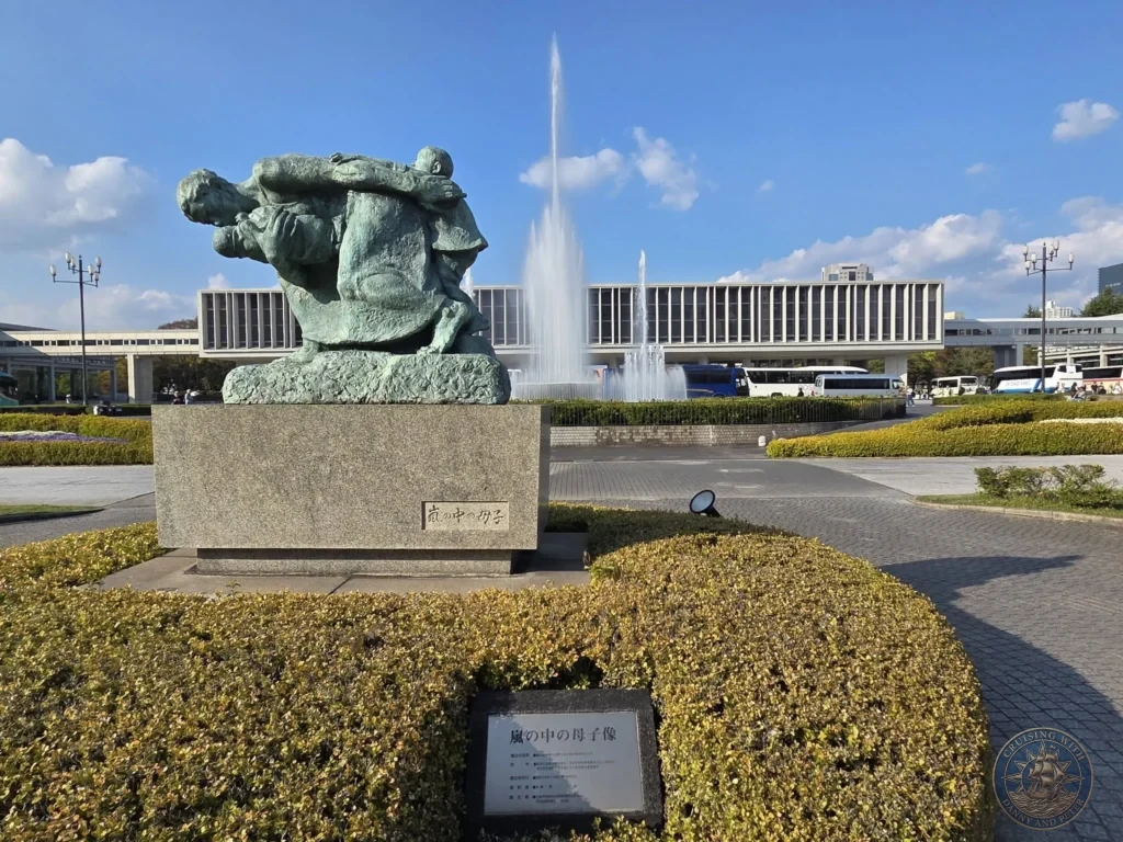 Hiroshima Japan Cruise Port Guide 2026 – Insider Tips & One Day Itinerary 28 The Mother and Baby in the Storm bronze statue located outside the Peace Memorial Museum with fountains shooting water in Hiroshima Japan. Hiroshima Japan Cruise Port Guide, DIY Hiroshima Cruise Port to City Center, Things to do in Hiroshima from cruise ship, Westerdam Hiroshima Docking Location, One day in Hiroshima Japan itinerary by Danny and Peter.