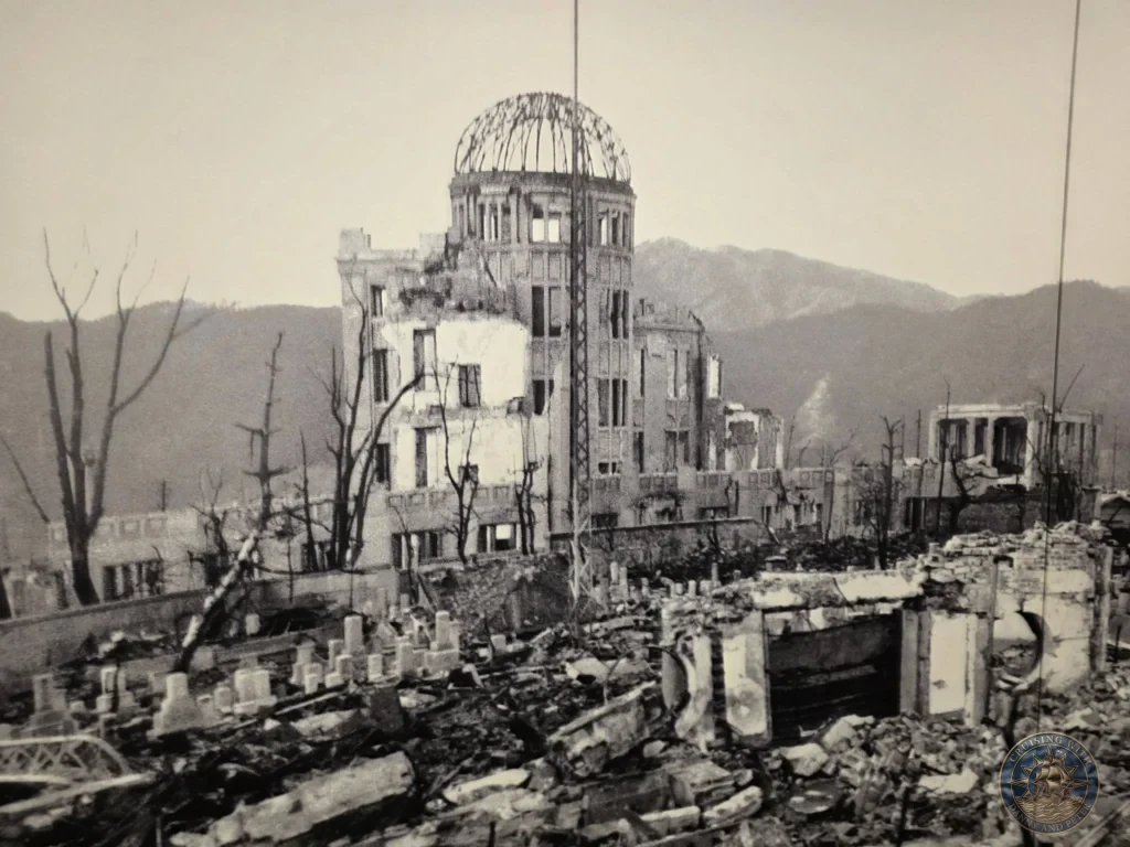 Hiroshima Japan Cruise Port Guide 2026 – Insider Tips & One Day Itinerary 64 Historical black-and-white photo display inside the Hiroshima National Peace Memorial Hall showing the skeletal remains of the Atomic Bomb Dome amidst ruins in Hiroshima Japan. Hiroshima Japan Cruise Port Guide, DIY Hiroshima Cruise Port to City Center, Things to do in Hiroshima from cruise ship, Westerdam Hiroshima Docking Location, One day in Hiroshima Japan itinerary by Danny and Peter.