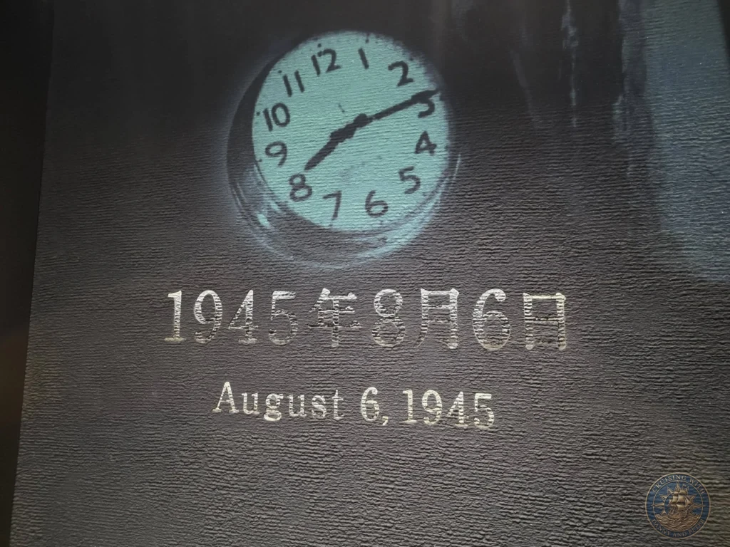 Hiroshima Japan Cruise Port Guide 2026 – Insider Tips & One Day Itinerary 66 An exhibit display inside the Hiroshima National Peace Memorial Hall featuring a clock frozen at 8:15 and the date August 6, 1945 in Hiroshima Japan. Hiroshima Japan Cruise Port Guide, DIY Hiroshima Cruise Port to City Center, Things to do in Hiroshima from cruise ship, Westerdam Hiroshima Docking Location, One day in Hiroshima Japan itinerary by Danny and Peter.