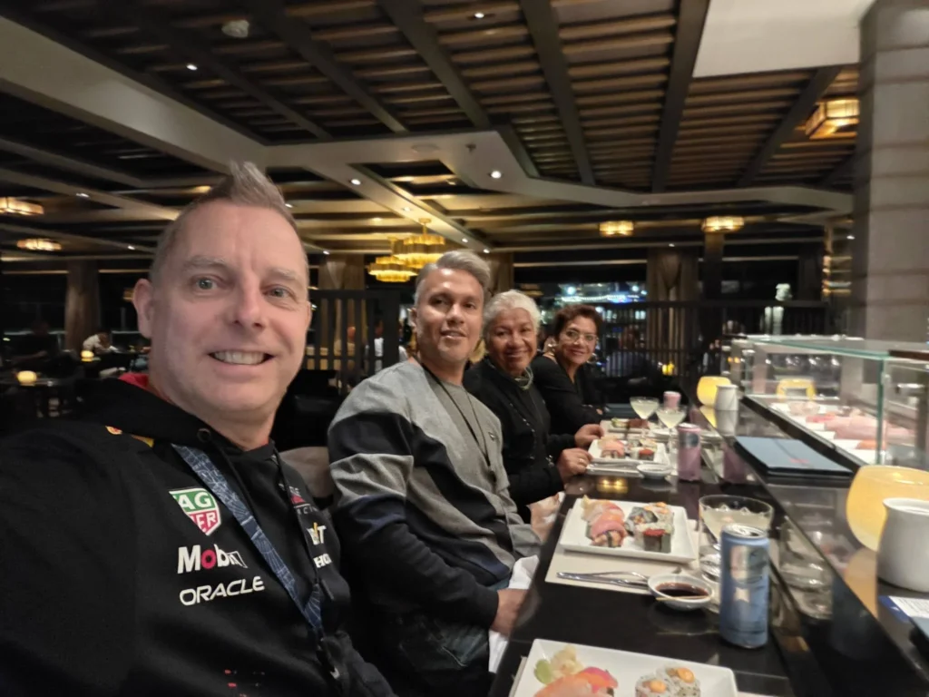 Peter taking a selfie with Danny, Danny's mother, and Danny's aunt seated at the sushi bar enjoying fresh dishes at Morimoto by Sea onboard Holland America Line's ship Rotterdam during a cruise to Ålesund. Things to do in Ålesund from cruise ship, by Danny and Peter.