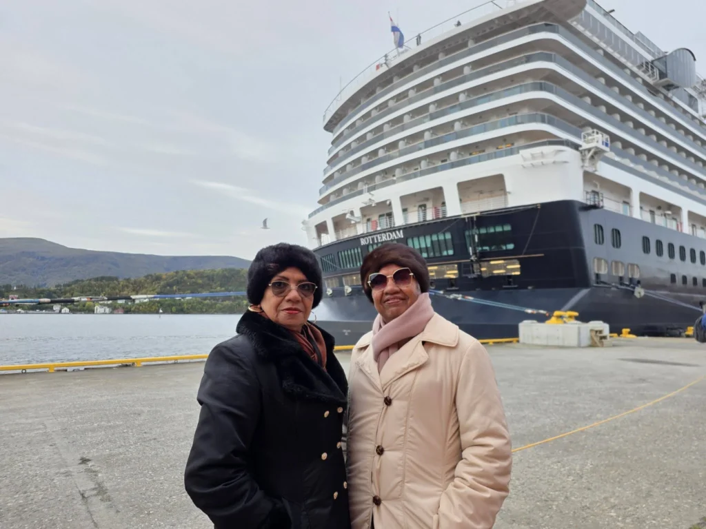 Danny's mother and aunt standing together on Storneskaia Quay right beside the stern of Holland America Line's Rotterdam in Ålesund, Norway. MS Rotterdam Ålesund Docking Location, by Danny and Peter.